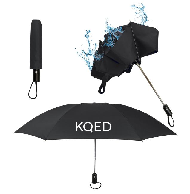 A black umbrella with KQED written on it in white
